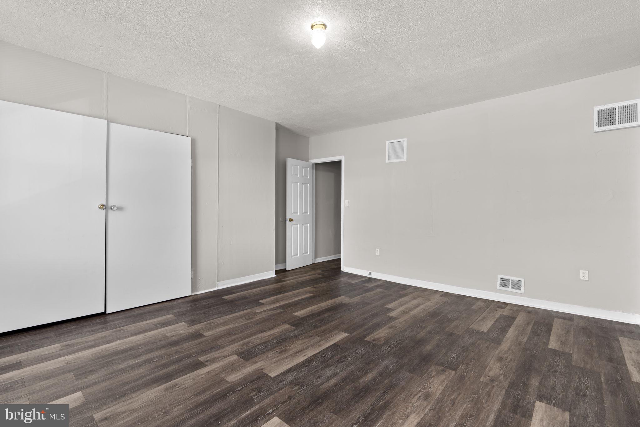 517 Mosher Street Baltimore, MD 21217 - Photo 16 of 45 a view of an empty room with wooden floor