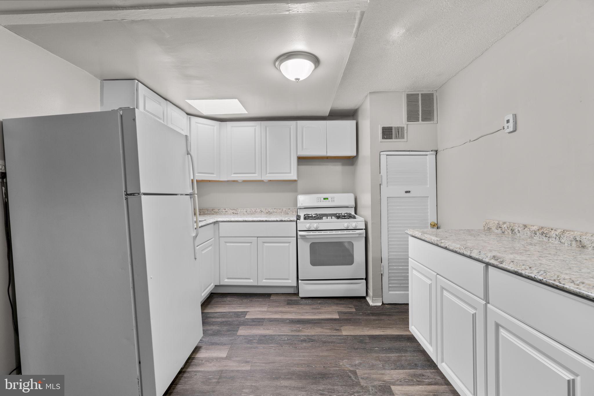 517 Mosher Street Baltimore, MD 21217 - Photo 18 of 45 a kitchen with white cabinets and white appliances