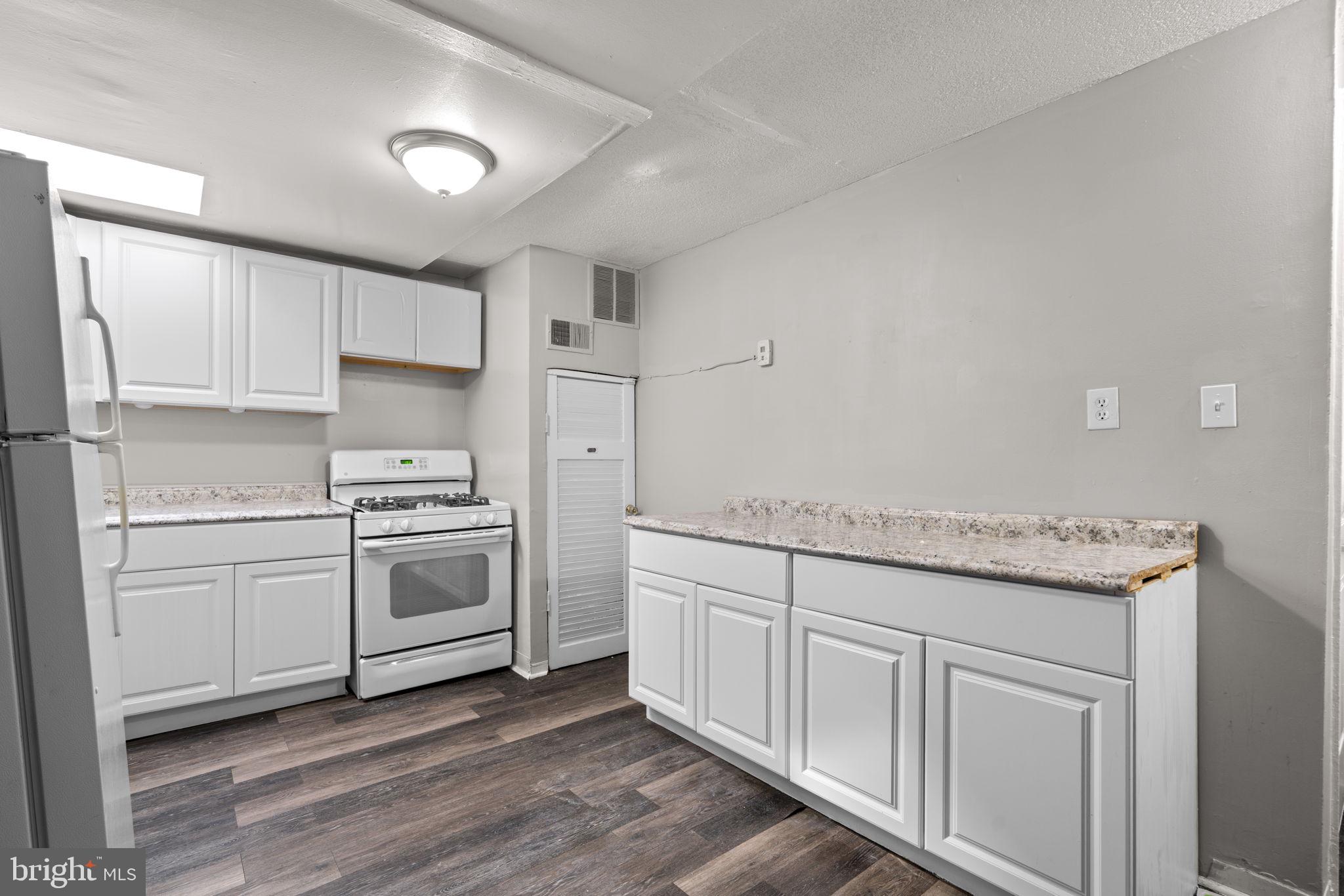 517 Mosher Street Baltimore, MD 21217 - Photo 19 of 45 a kitchen with white cabinets and white appliances
