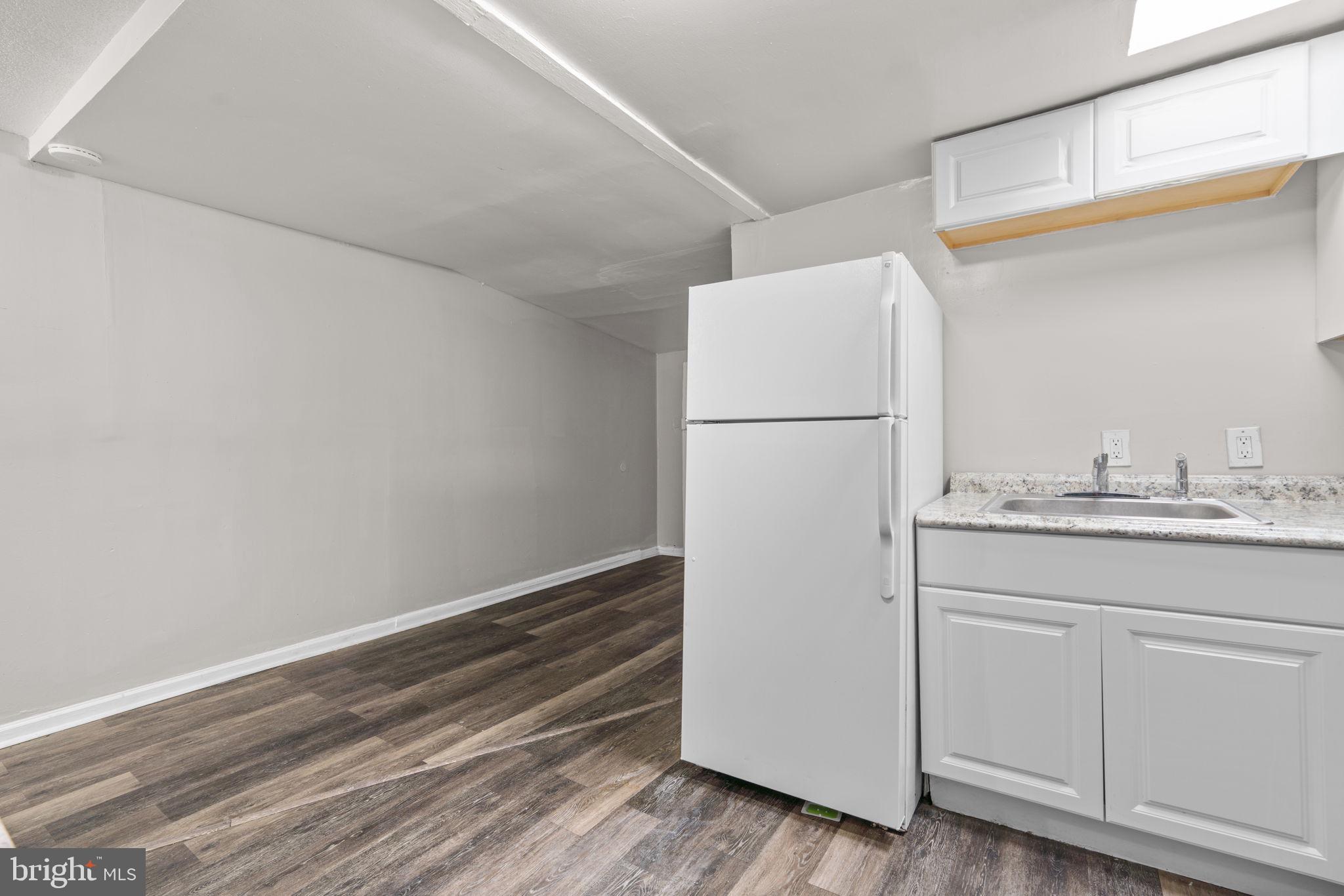 517 Mosher Street Baltimore, MD 21217 - Photo 22 of 45 a utility room with cabinets