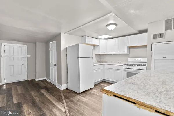 a kitchen with a refrigerator and a sink