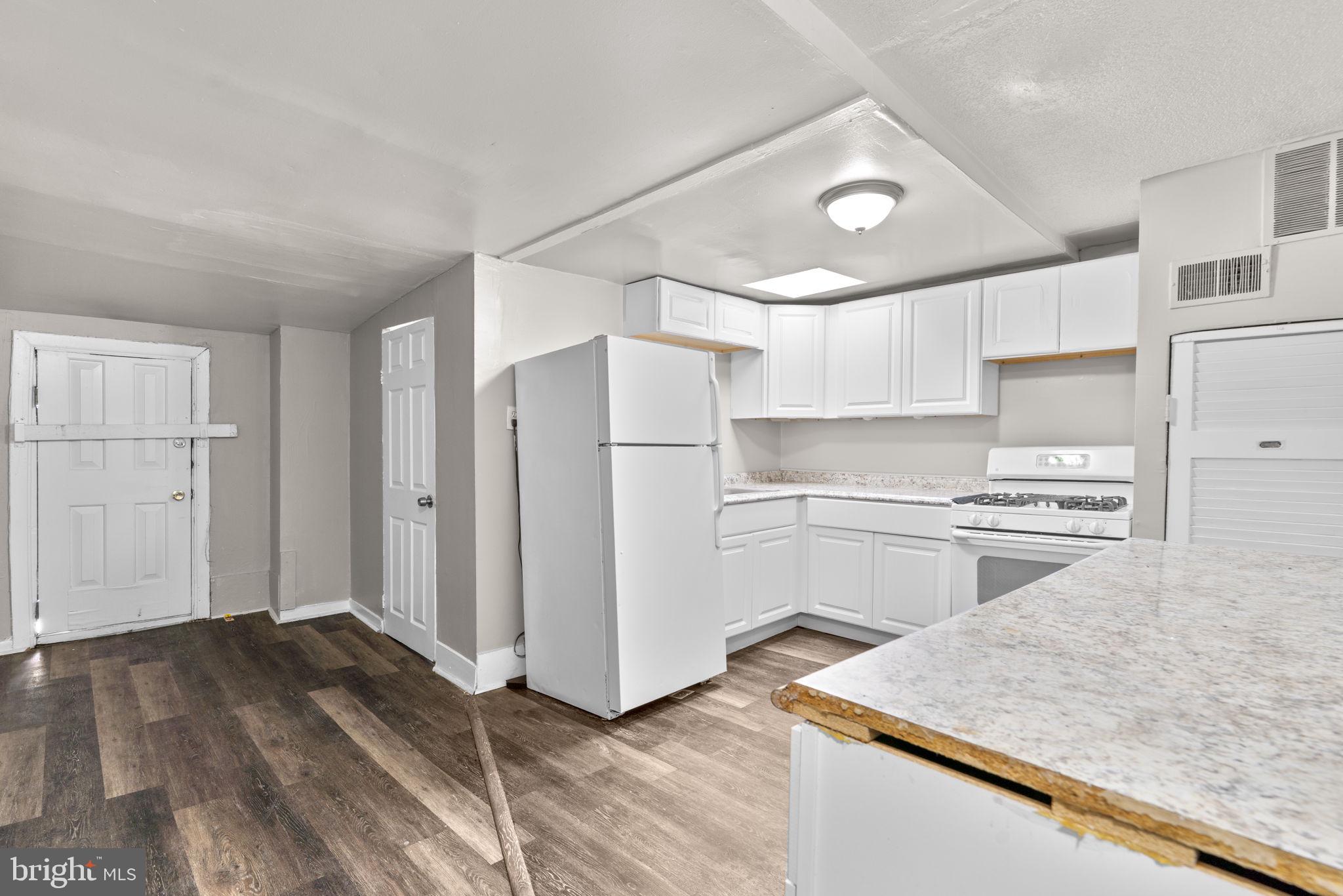 517 Mosher Street Baltimore, MD 21217 - Photo 23 of 45 a kitchen with a refrigerator and a sink