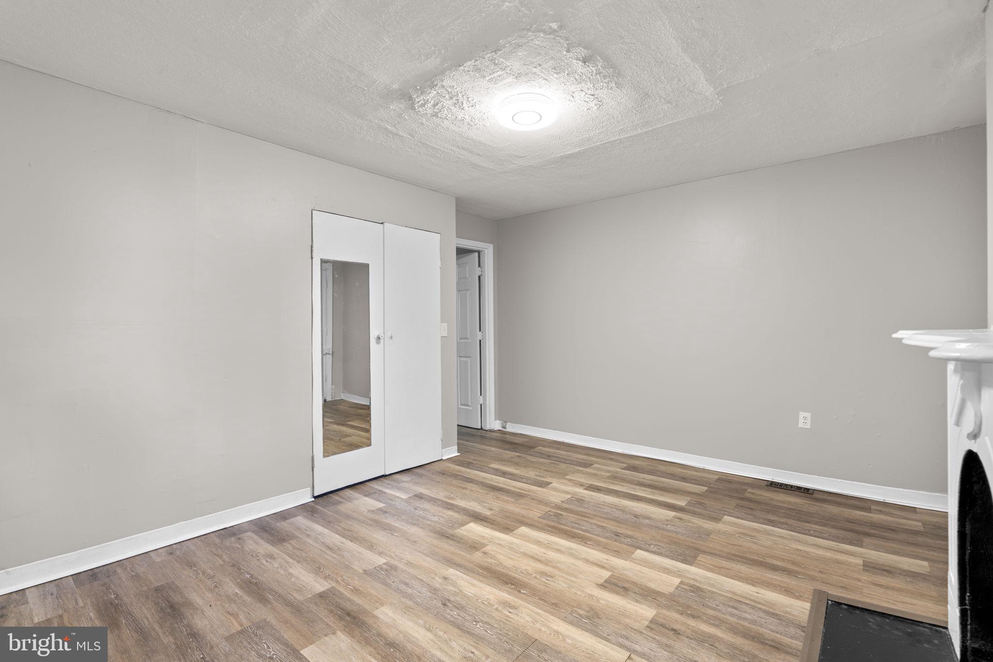 517 Mosher Street Baltimore, MD 21217 - Photo 26 of 45 a view of an empty room with wooden floor and a window