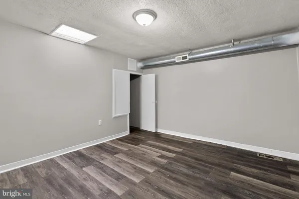 a view of room with wooden floor