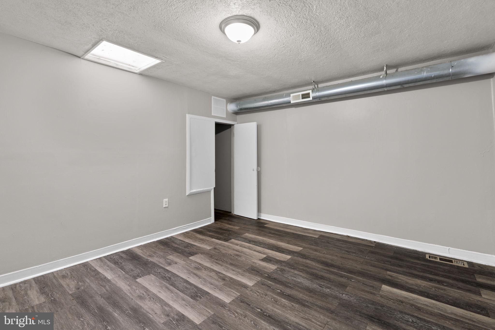 517 Mosher Street Baltimore, MD 21217 - Photo 28 of 45 a view of room with wooden floor