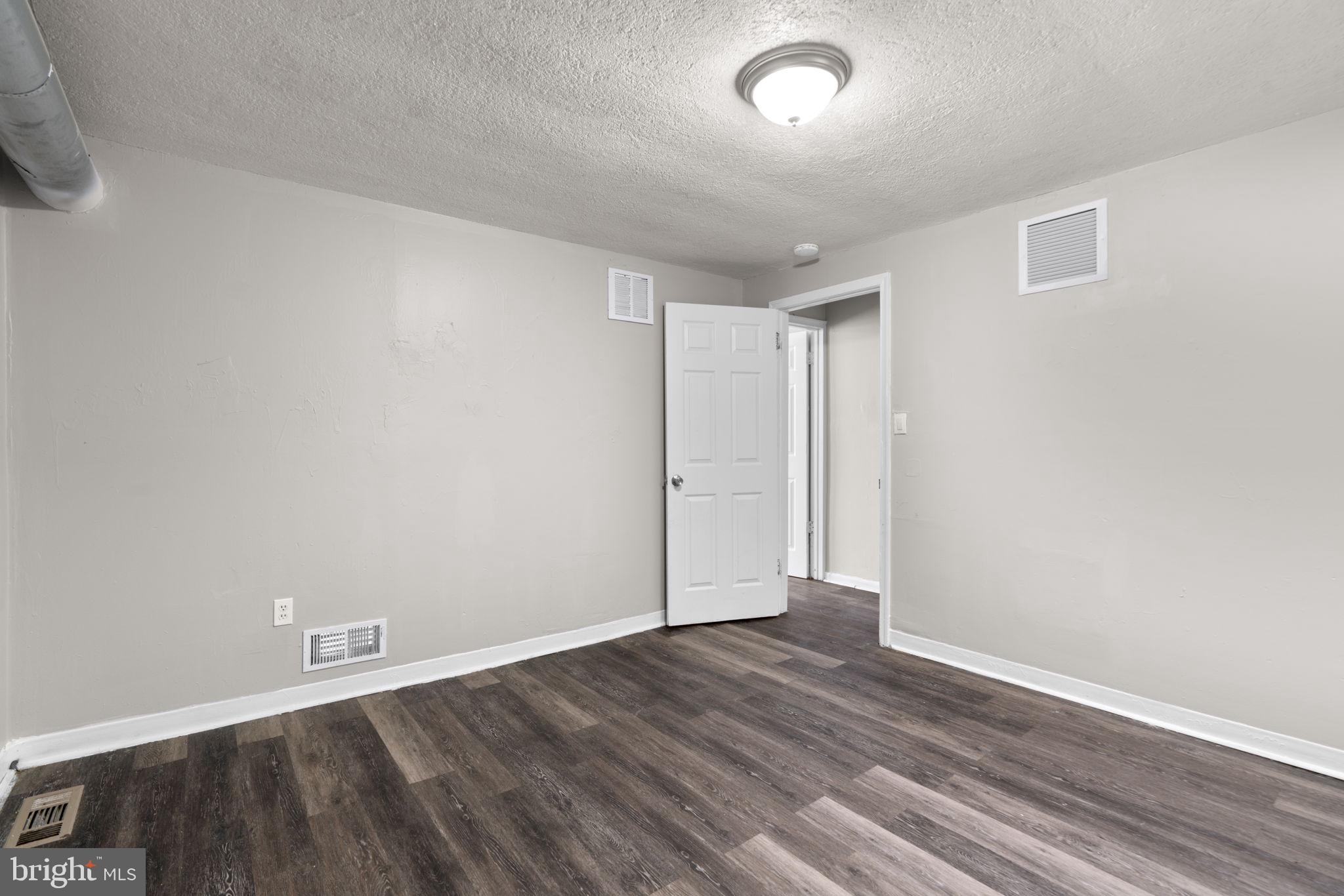 517 Mosher Street Baltimore, MD 21217 - Photo 29 of 45 wooden floor in an empty room