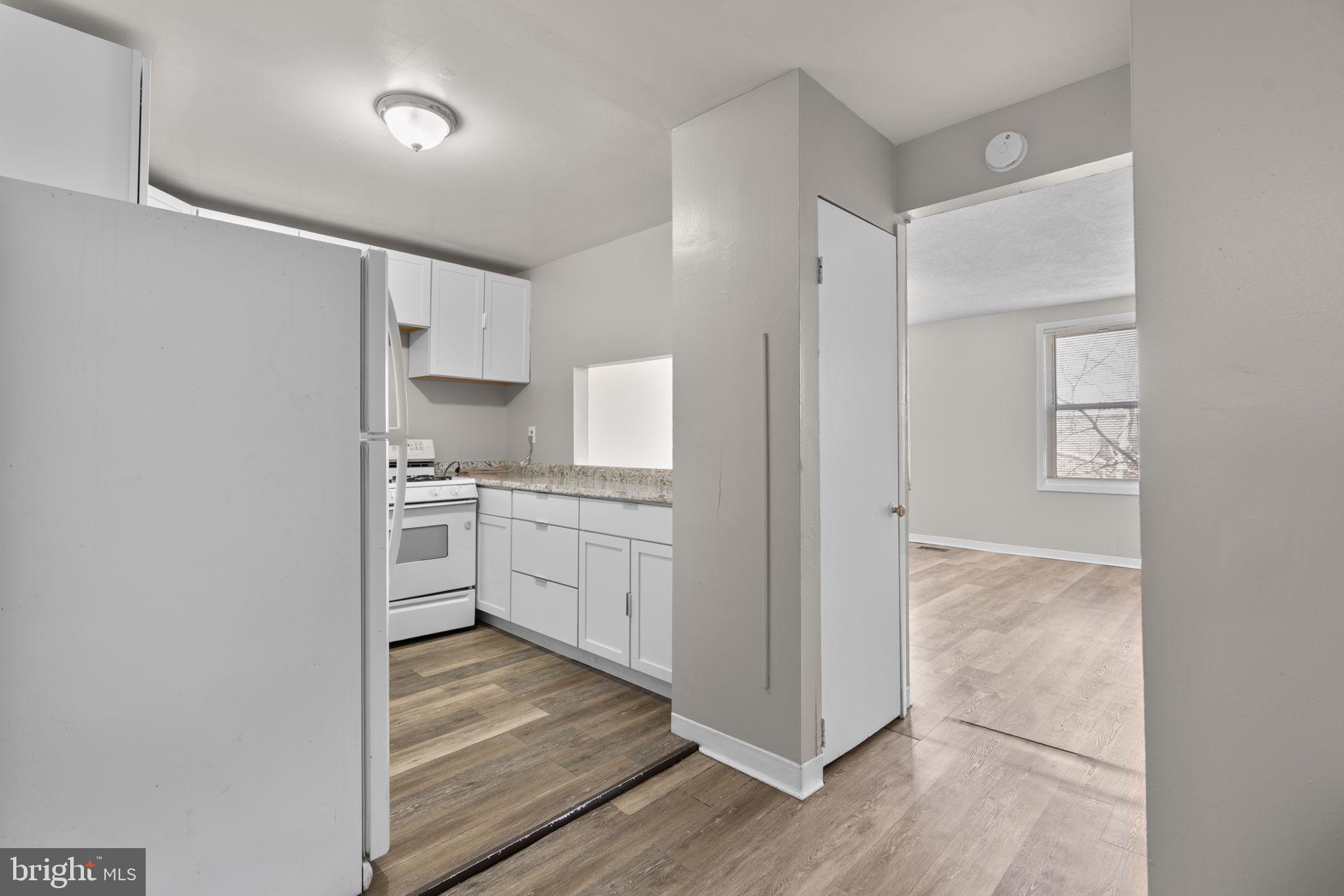 517 Mosher Street Baltimore, MD 21217 - Photo 3 of 45 a kitchen with white cabinets and white appliances