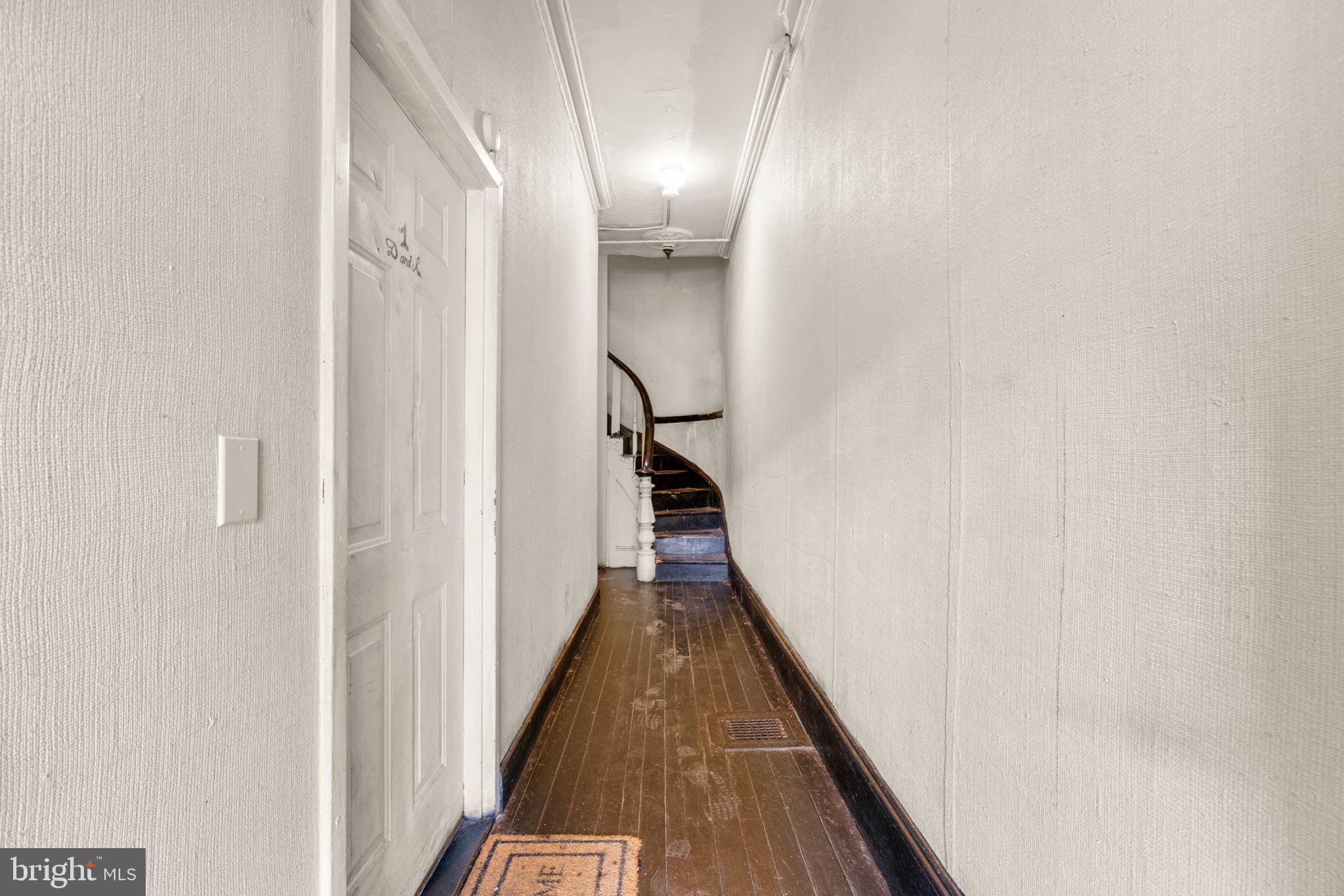517 Mosher Street Baltimore, MD 21217 - Photo 34 of 45 a view of a hallway with wooden floor and staircase
