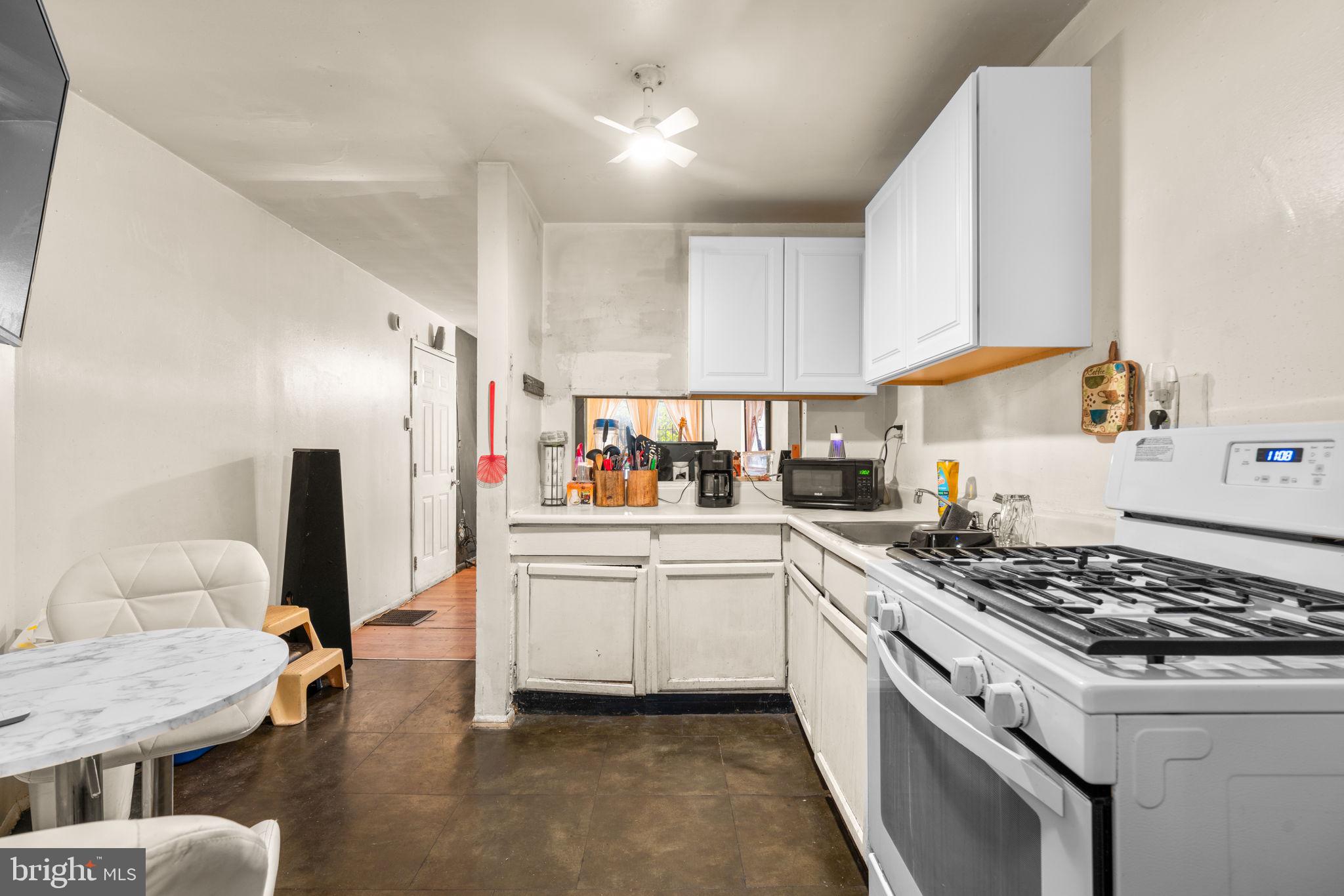 517 Mosher Street Baltimore, MD 21217 - Photo 38 of 45 a kitchen with stainless steel appliances granite countertop a sink stove and refrigerator