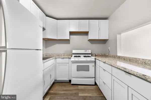 a kitchen with cabinets appliances and a sink