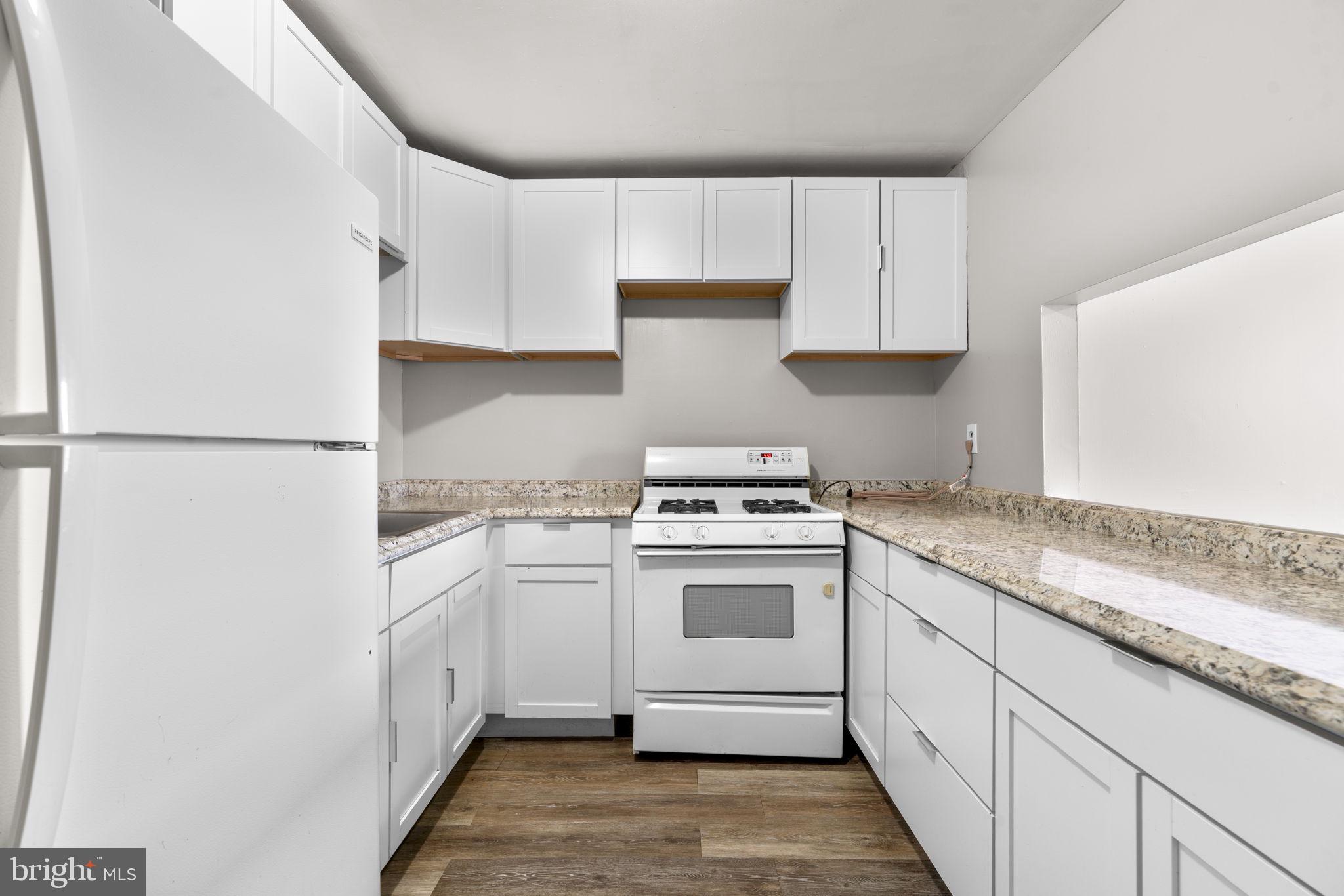517 Mosher Street Baltimore, MD 21217 - Photo 5 of 45 a kitchen with cabinets appliances and a sink