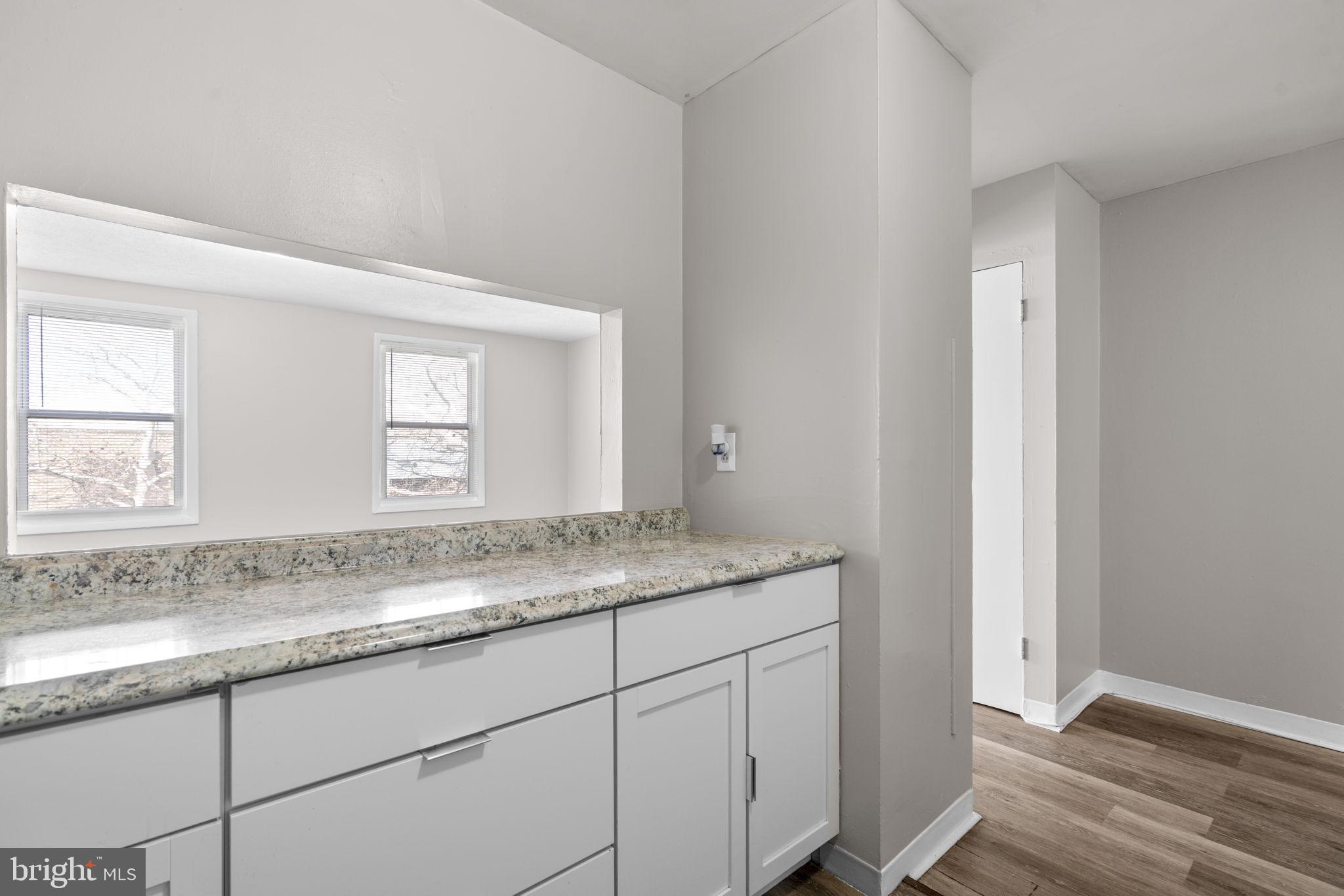517 Mosher Street Baltimore, MD 21217 - Photo 7 of 45 a bathroom with a granite countertop sink and mirror