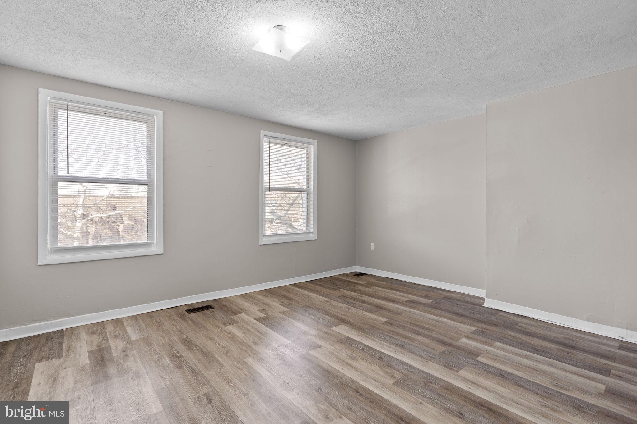517 Mosher Street Baltimore, MD 21217 - Photo 9 of 45 a view of an empty room with wooden floor and a window
