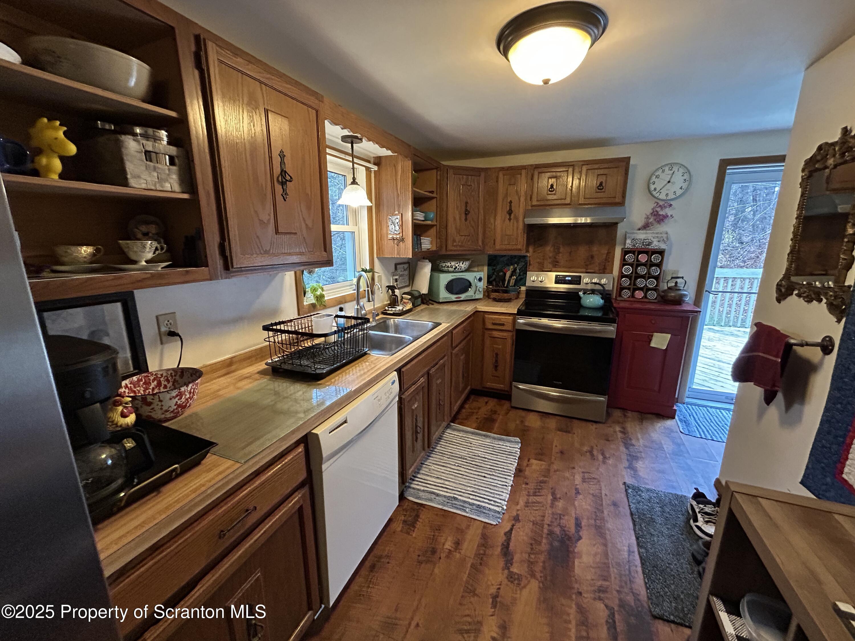 7 Hollow Crest Road Tunkhannock, PA 18657 - Photo 13 of 41 a kitchen with wooden cabinets and a stove top oven