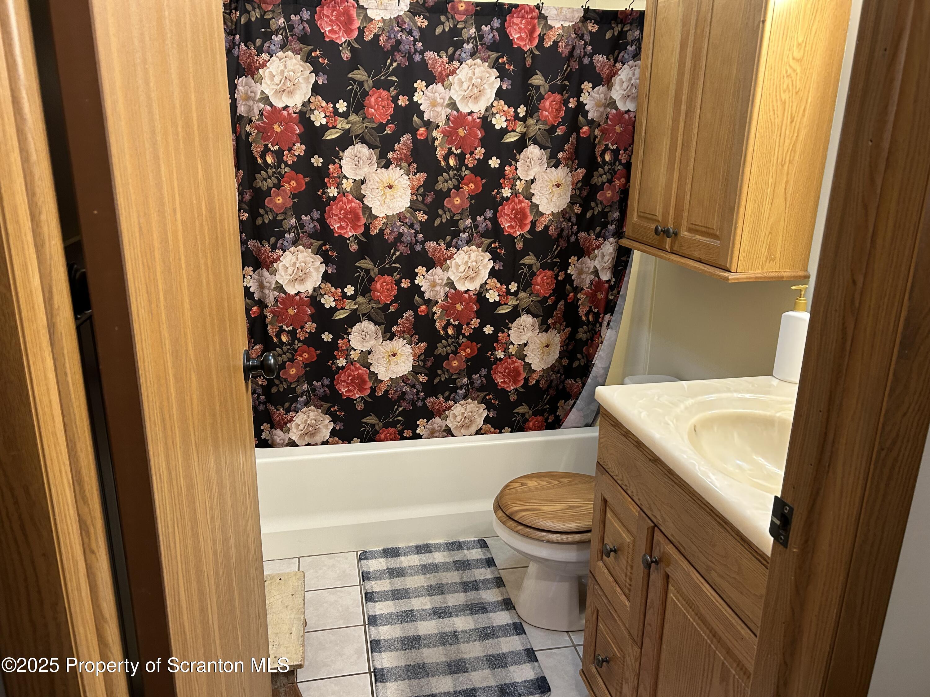 7 Hollow Crest Road Tunkhannock, PA 18657 - Photo 19 of 41 a bathroom with a toilet and a shower curtain