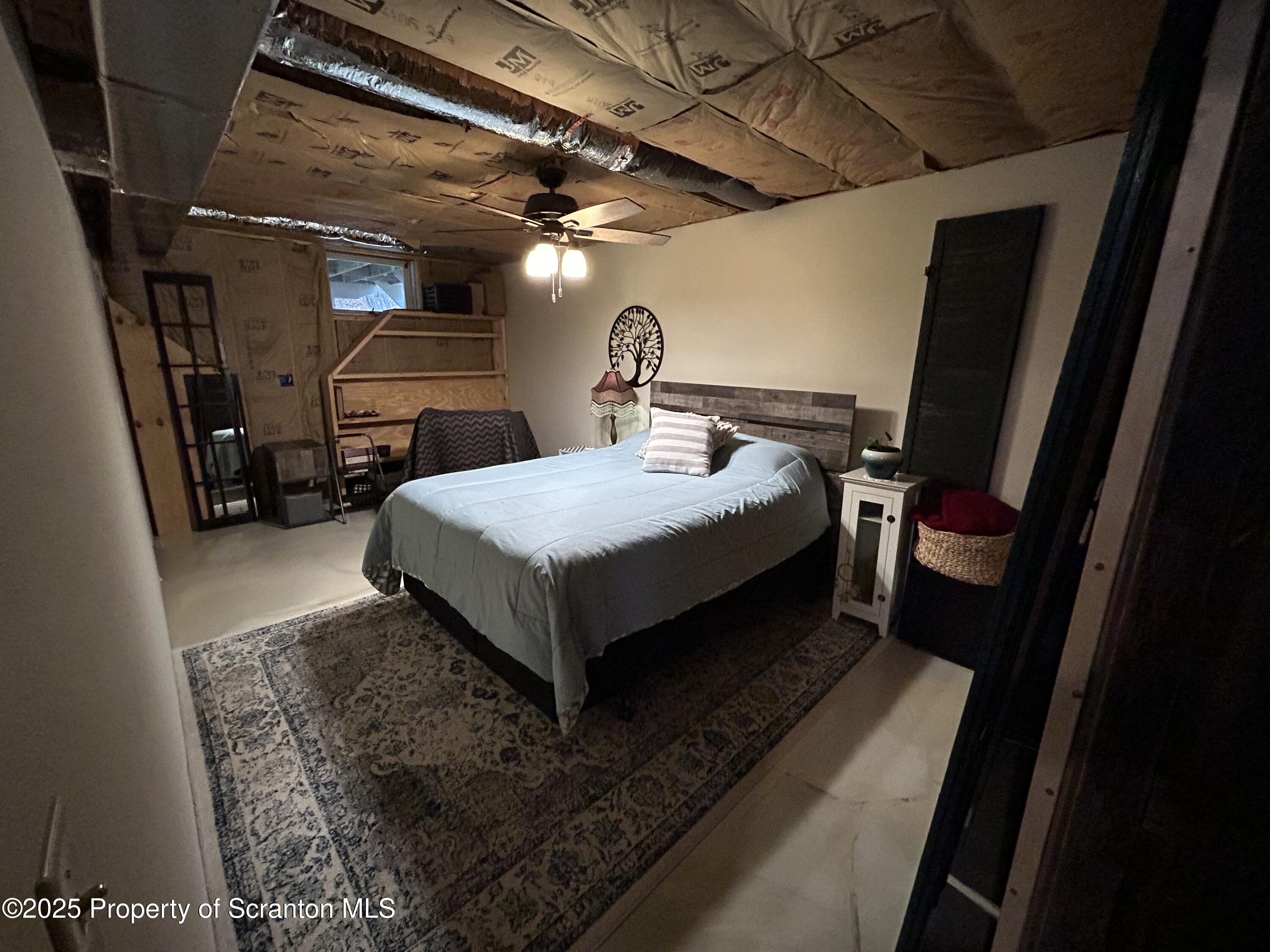 7 Hollow Crest Road Tunkhannock, PA 18657 - Photo 34 of 41 a bed sitting in a room next to a window