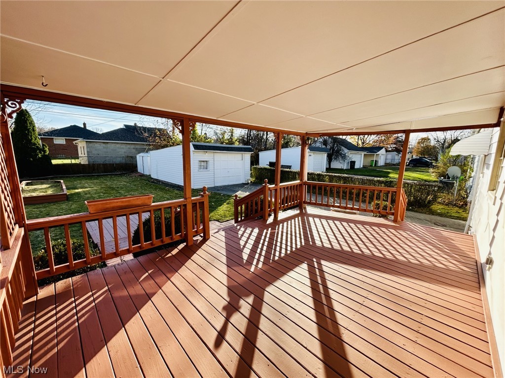 13414 Rockside Road Garfield Heights, OH 44125 - Photo 18 of 25 Wooden deck with a lawn and a garage