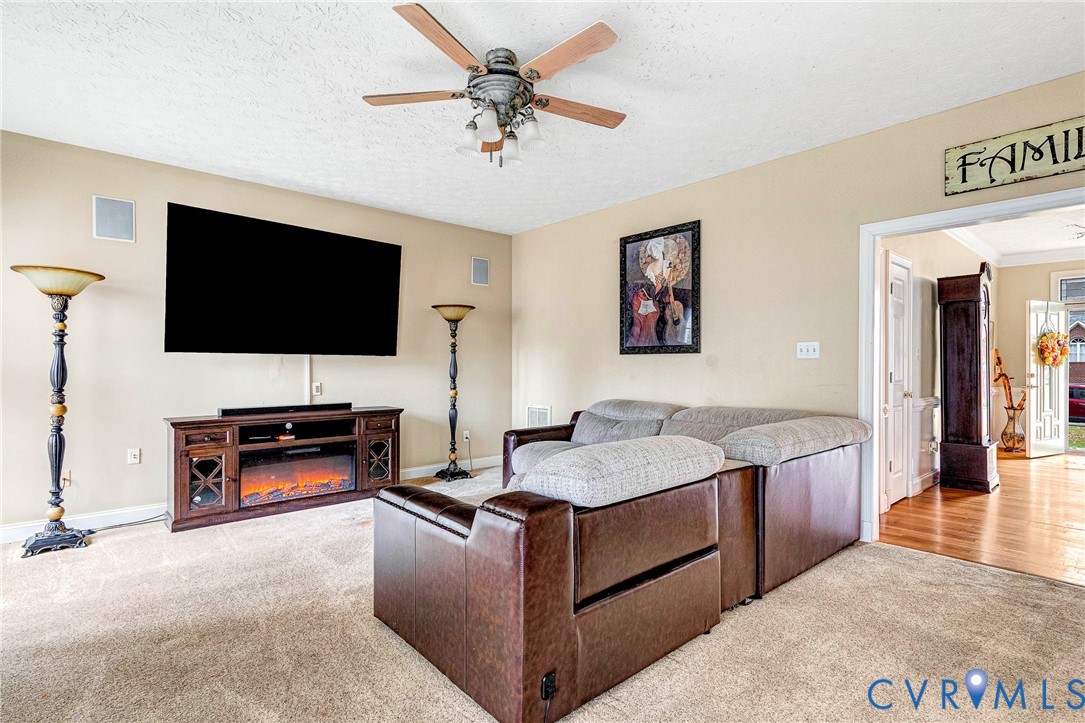 9212 Wyattwood Road Mechanicsville, VA 23116 - Photo 12 of 47 a living room with furniture and a flat screen tv