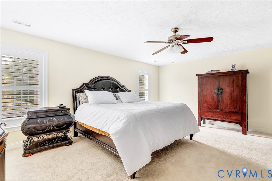 9212 Wyattwood Road Mechanicsville, VA 23116 - Photo 15 of 47 a bedroom with a bed and dresser