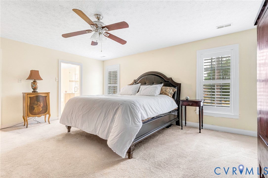 9212 Wyattwood Road Mechanicsville, VA 23116 - Photo 16 of 47 a bedroom with a bed and a table