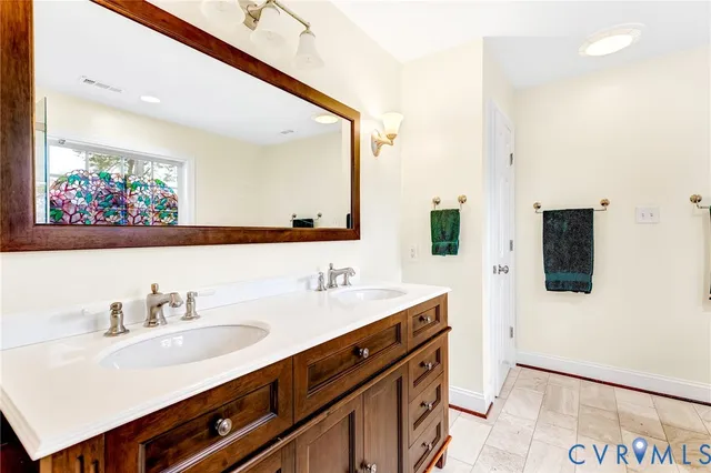 a bathroom with a sink double vanity and a mirror