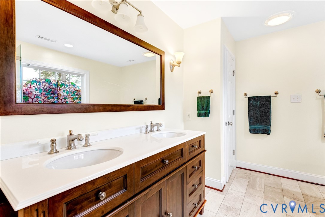 9212 Wyattwood Road Mechanicsville, VA 23116 - Photo 19 of 47 a bathroom with a sink double vanity and a mirror