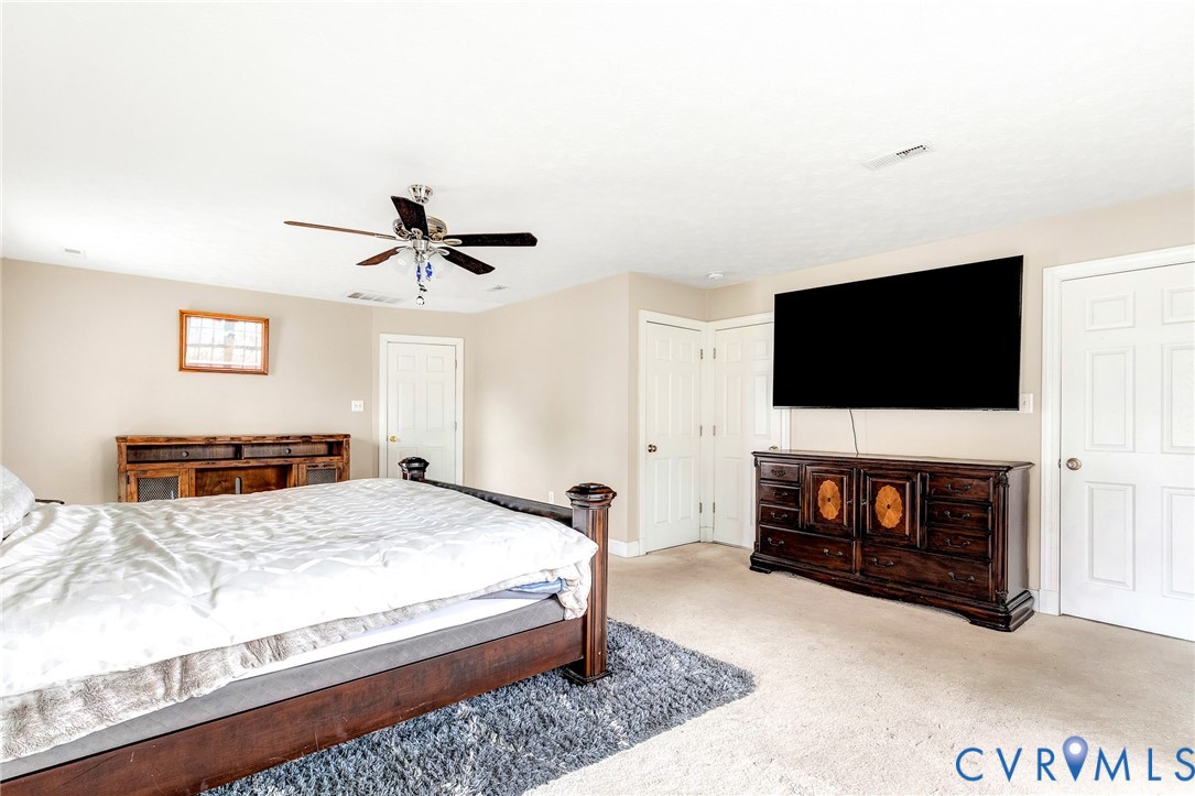 9212 Wyattwood Road Mechanicsville, VA 23116 - Photo 24 of 47 a bedroom with a bed and a flat screen tv