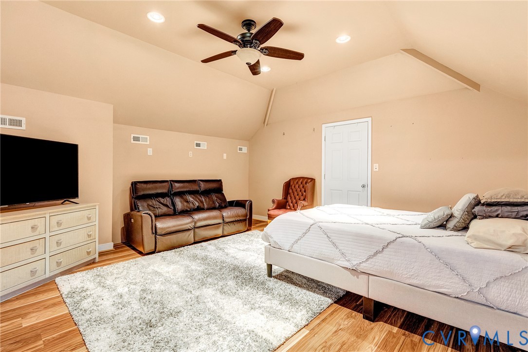 9212 Wyattwood Road Mechanicsville, VA 23116 - Photo 28 of 47 a bedroom with a bed a flat screen tv and a couch