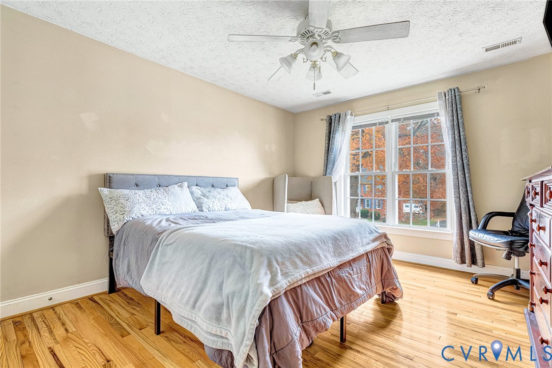 9212 Wyattwood Road Mechanicsville, VA 23116 - Photo 35 of 47 a bedroom with a bed and wooden floor