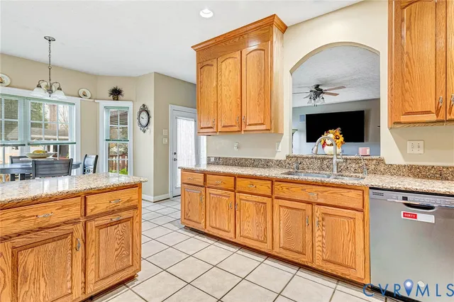 a kitchen with granite countertop a sink stainless steel appliances and cabinets