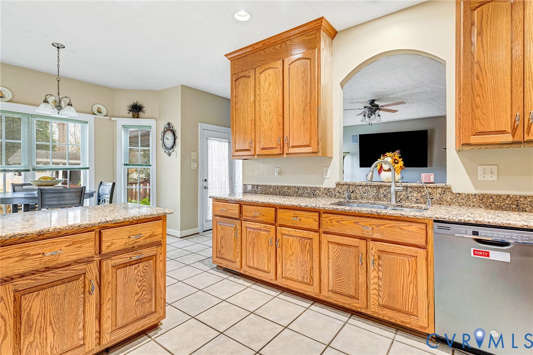 9212 Wyattwood Road Mechanicsville, VA 23116 - Photo 6 of 47 a kitchen with granite countertop a sink stainless steel appliances and cabinets
