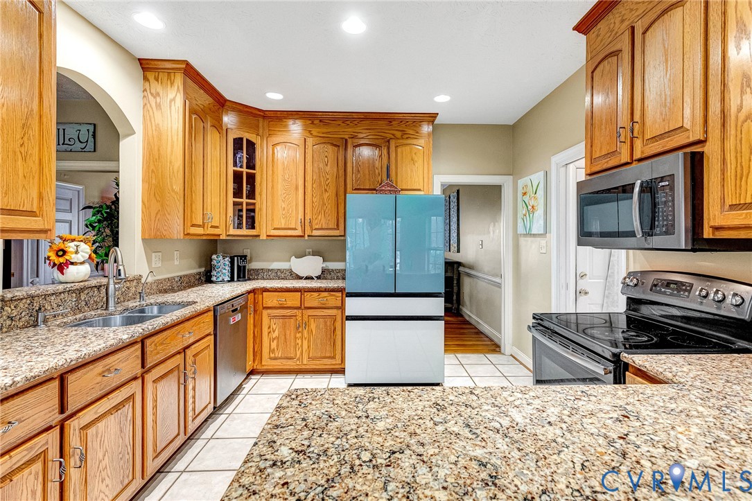 9212 Wyattwood Road Mechanicsville, VA 23116 - Photo 7 of 47 a kitchen with stainless steel appliances granite countertop a refrigerator a stove top oven and sink