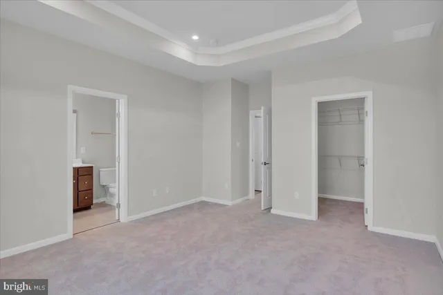 a view of an empty room and closet area