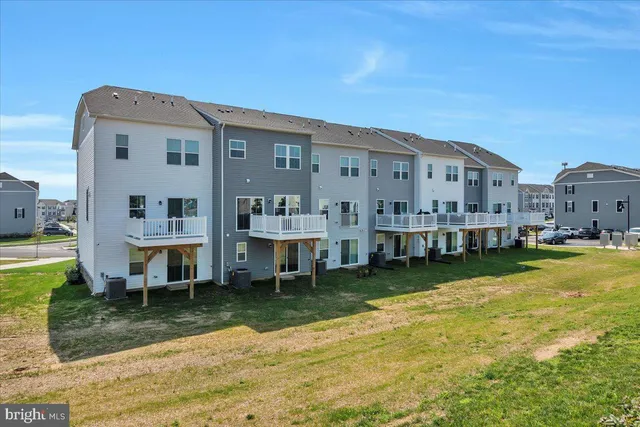 a view of a house with a yard patio and sitting area