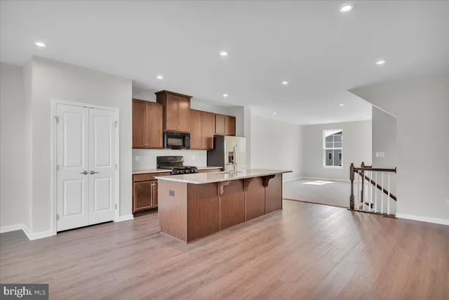 a kitchen with stainless steel appliances granite countertop a stove a sink and a refrigerator