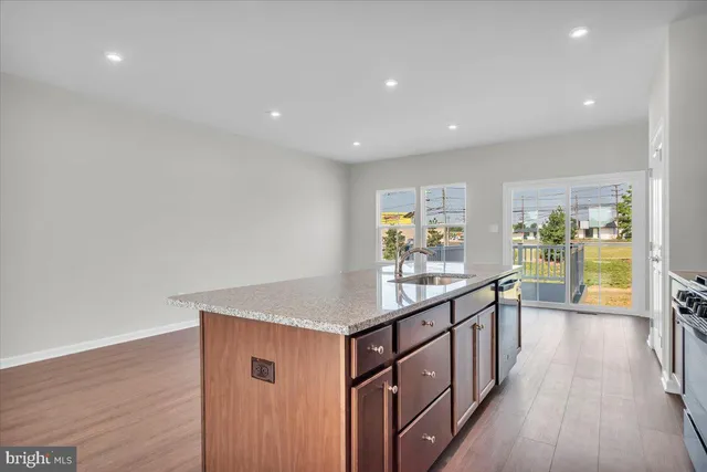 a view of hallway with wooden floor and furniture