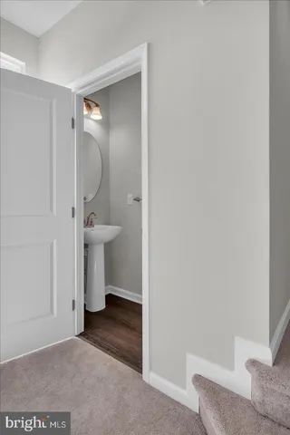 a view of a bathroom with a sink and a mirror