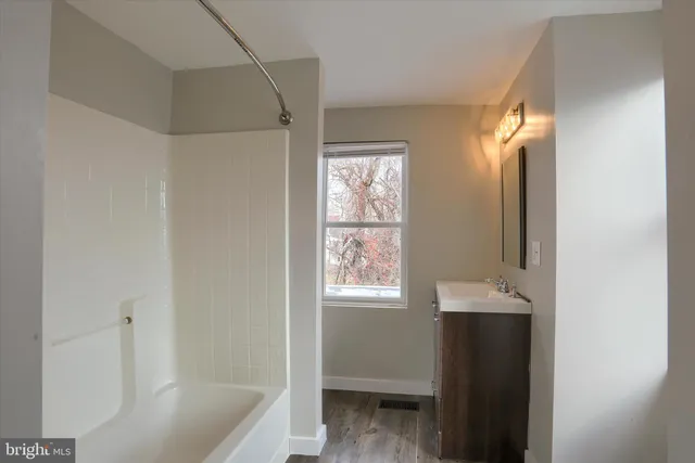 a bathroom with a bathtub and a sink