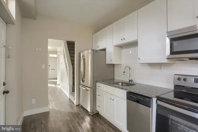 a kitchen with stainless steel appliances a refrigerator stove and sink