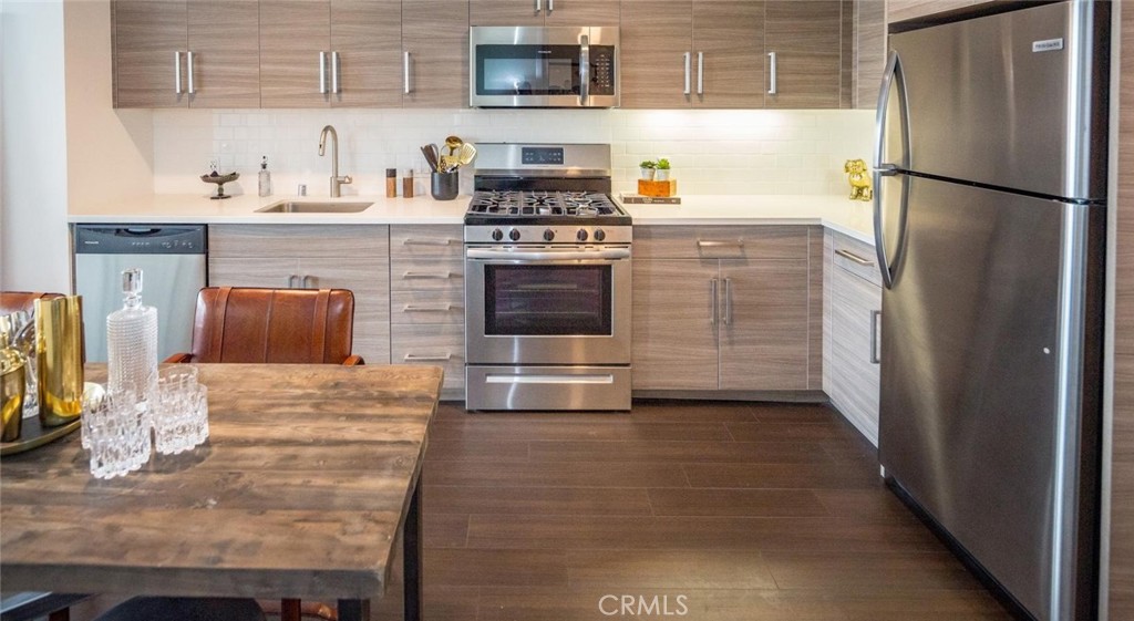 150 Van Ness Avenue, Unit 1222 San Francisco, CA 94102 - Photo 5 of 75 a kitchen with granite countertop a refrigerator and a stove