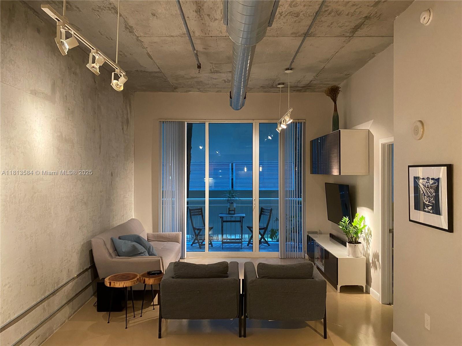 2001 Biscayne Boulevard, Unit 3203 Miami, FL 33137 - Photo 2 of 15 a living room with furniture and a fireplace