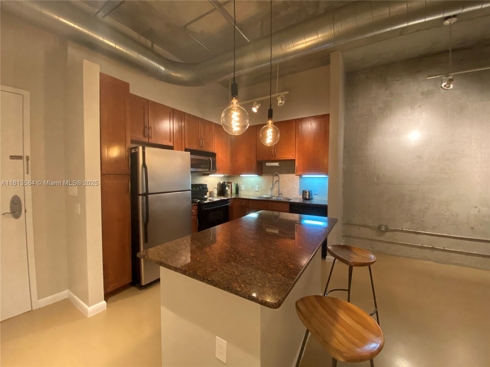 2001 Biscayne Boulevard, Unit 3203 Miami, FL 33137 - Photo 7 of 15 a kitchen with stainless steel appliances granite countertop a sink and a refrigerator