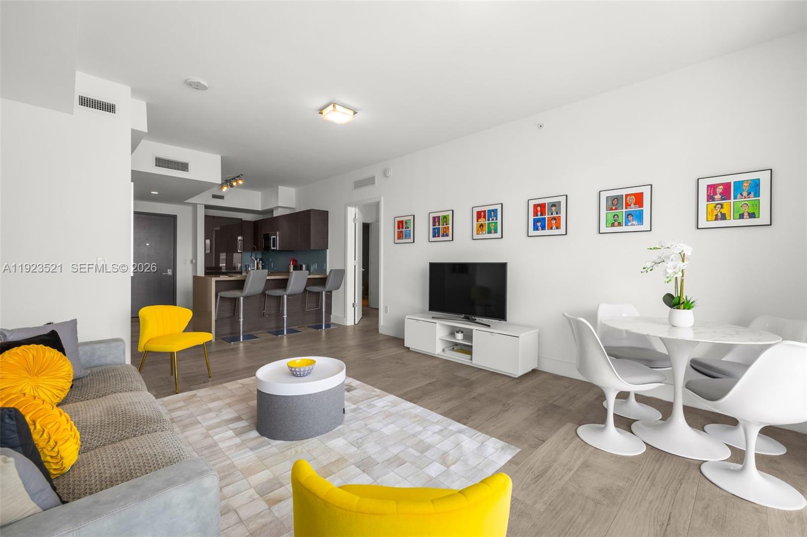 1080 Brickell Avenue, Unit 3602 Miami, FL 33131 - Photo 13 of 45 a living room with furniture and a flat screen tv