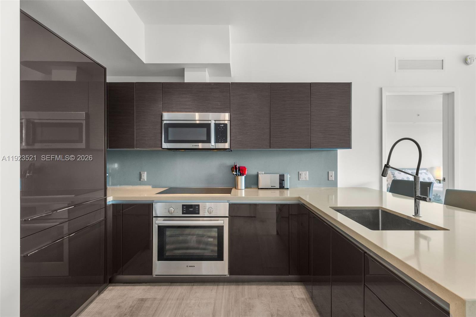 1080 Brickell Avenue, Unit 3602 Miami, FL 33131 - Photo 15 of 45 a kitchen with sink a microwave and cabinets
