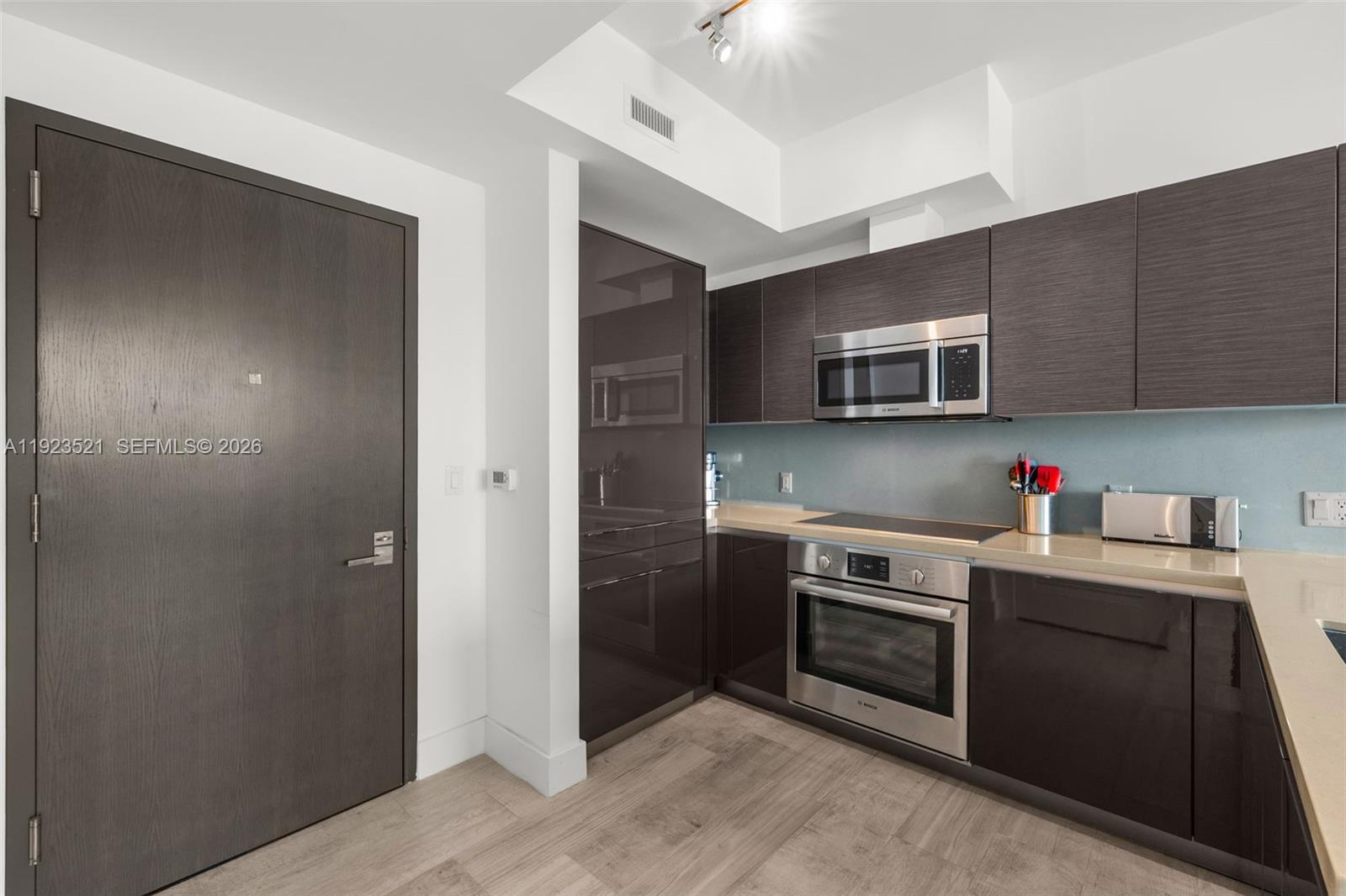 1080 Brickell Avenue, Unit 3602 Miami, FL 33131 - Photo 16 of 45 a kitchen with stainless steel appliances granite countertop a refrigerator and a stove top oven