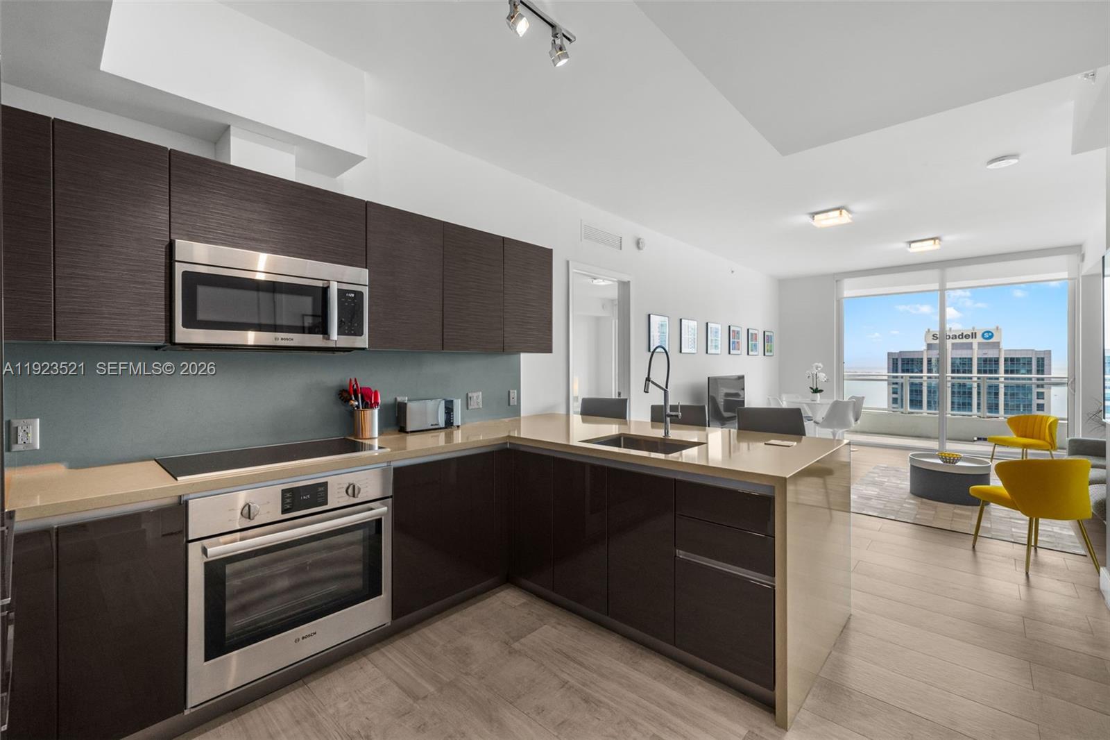 1080 Brickell Avenue, Unit 3602 Miami, FL 33131 - Photo 17 of 45 a kitchen with a sink stove and microwave