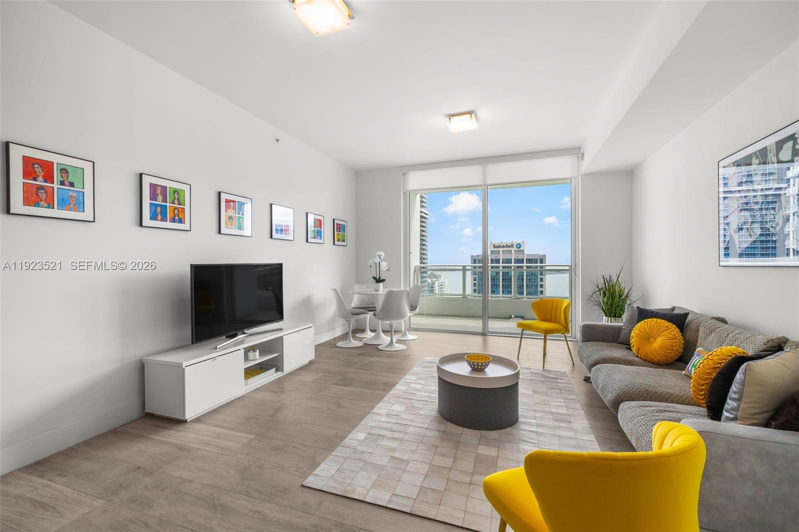 1080 Brickell Avenue, Unit 3602 Miami, FL 33131 - Photo 2 of 45 a living room with furniture and a flat screen tv