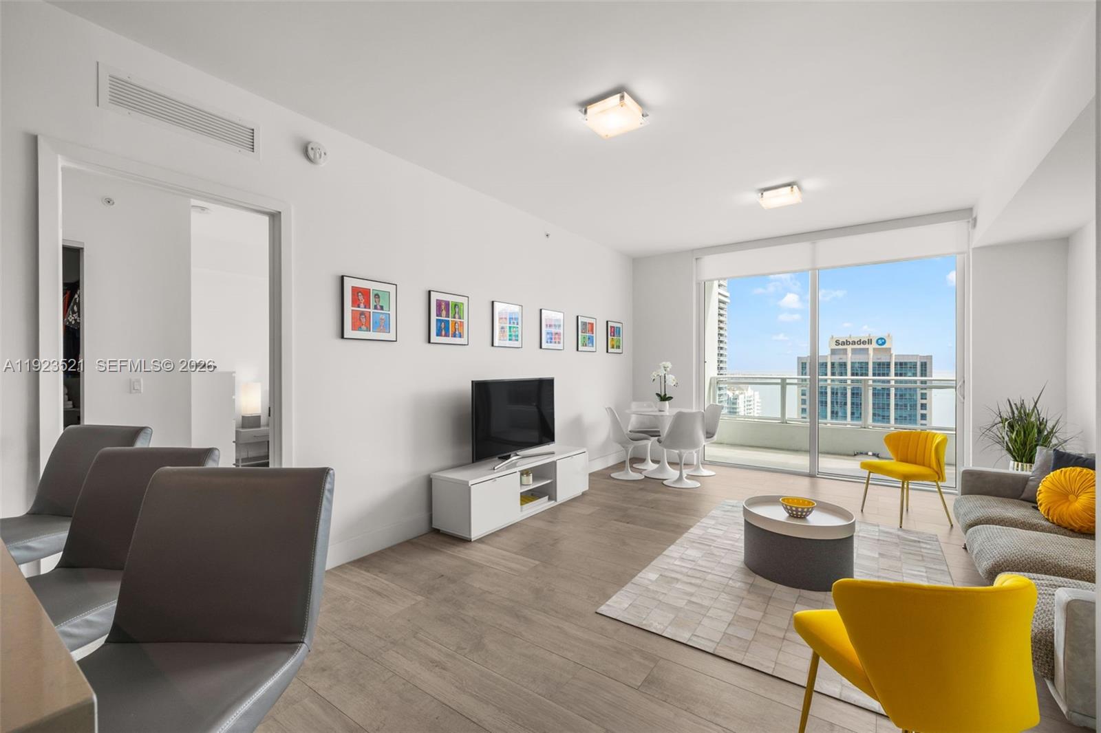 1080 Brickell Avenue, Unit 3602 Miami, FL 33131 - Photo 21 of 45 a living room with furniture and a flat screen tv