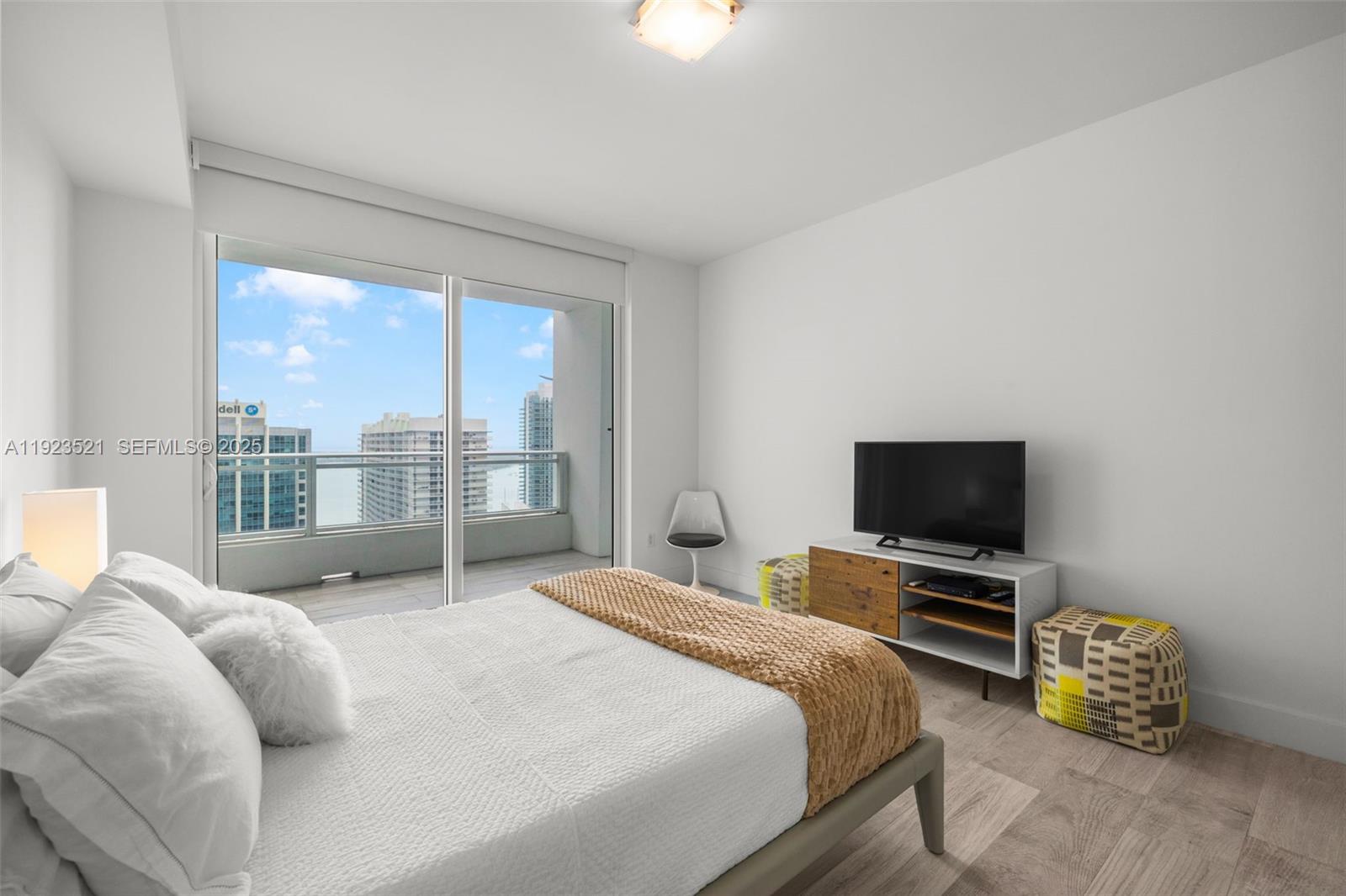 1080 Brickell Avenue, Unit 3602 Miami, FL 33131 - Photo 24 of 45 a bedroom with a bed and glass window