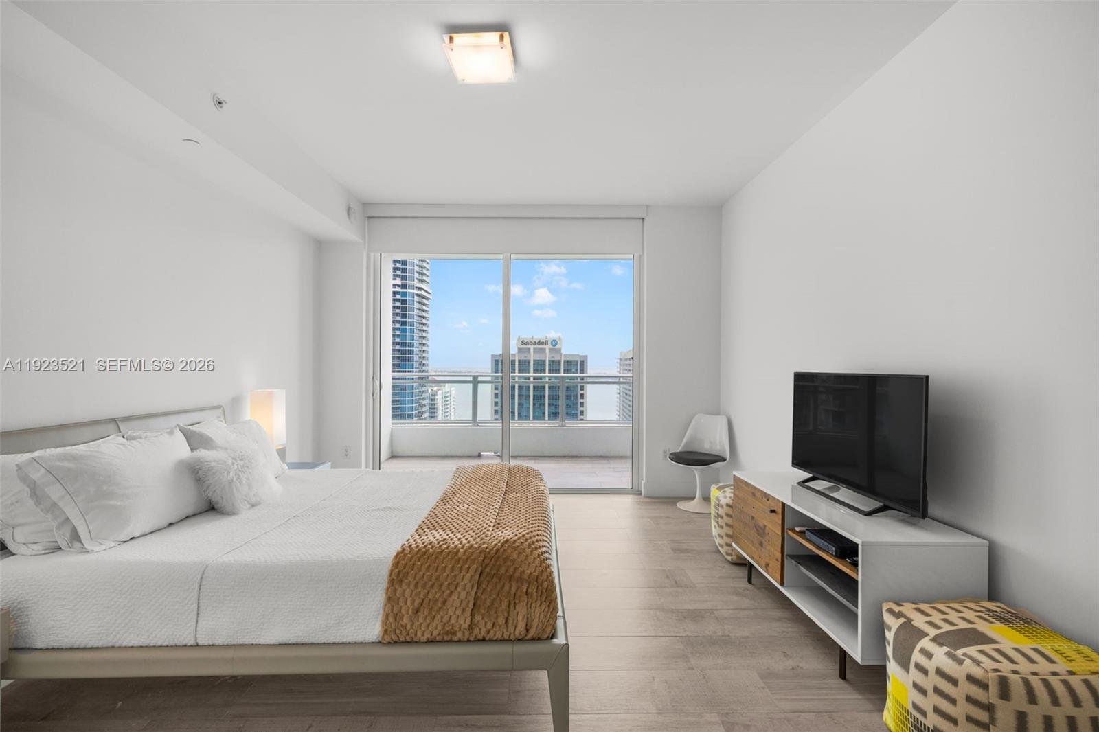 1080 Brickell Avenue, Unit 3602 Miami, FL 33131 - Photo 25 of 45 a living room with furniture and a flat screen tv